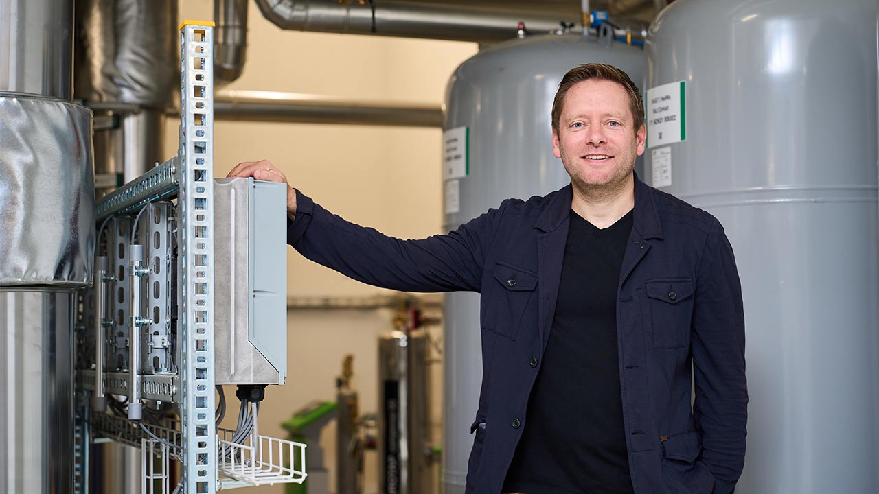 Carsten Meister von IBS steht vor dem Fernwärmeumformer